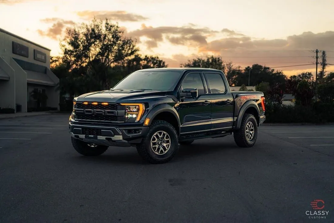 Black Ford F-150 Raptor at sunset