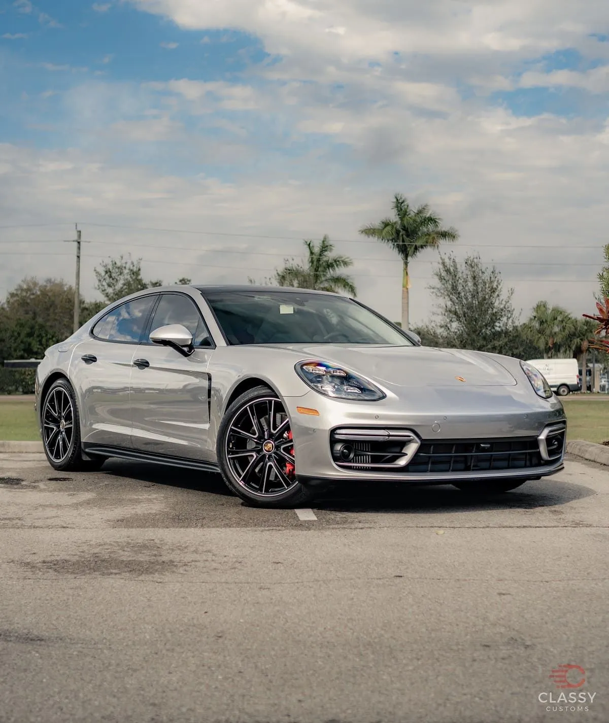Silver Porsche Panamera parked outside the shop