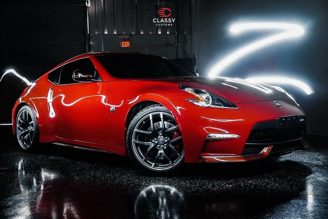 Red Nissan 370Z under shop lights