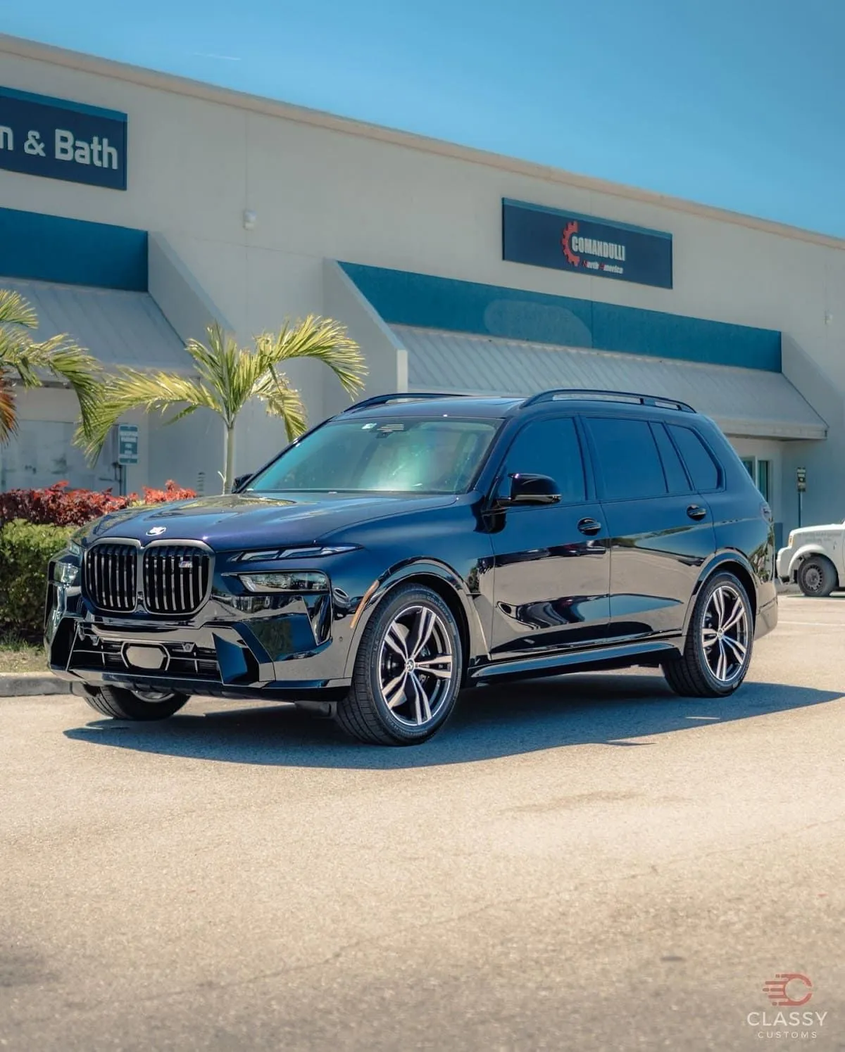 Dark BMW SUV in front of the shop