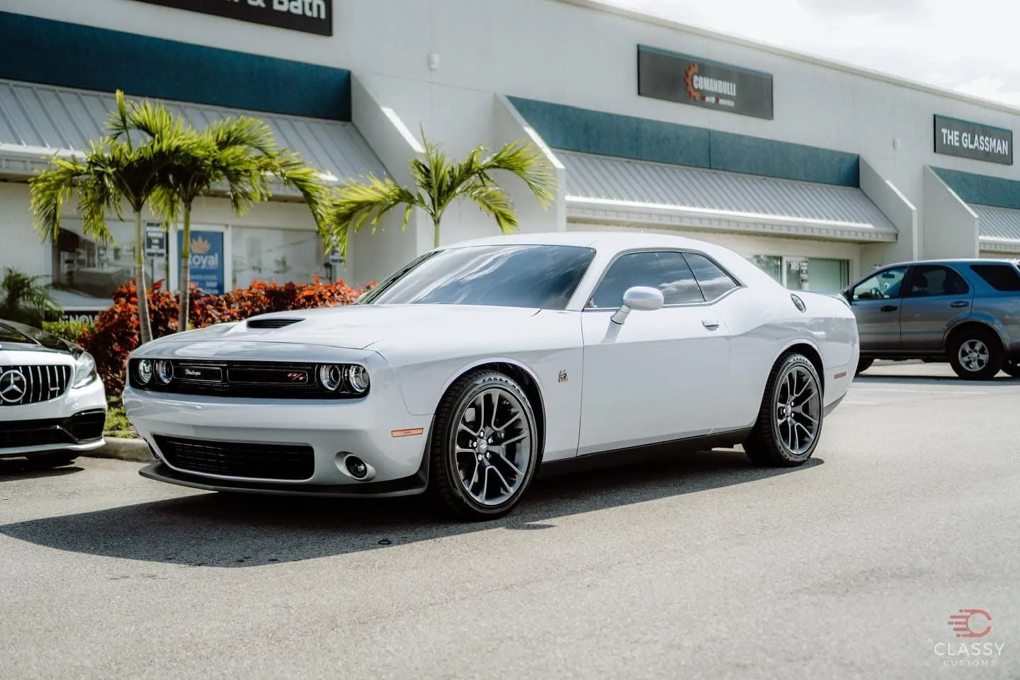 White Dodge Challenger outside the shop