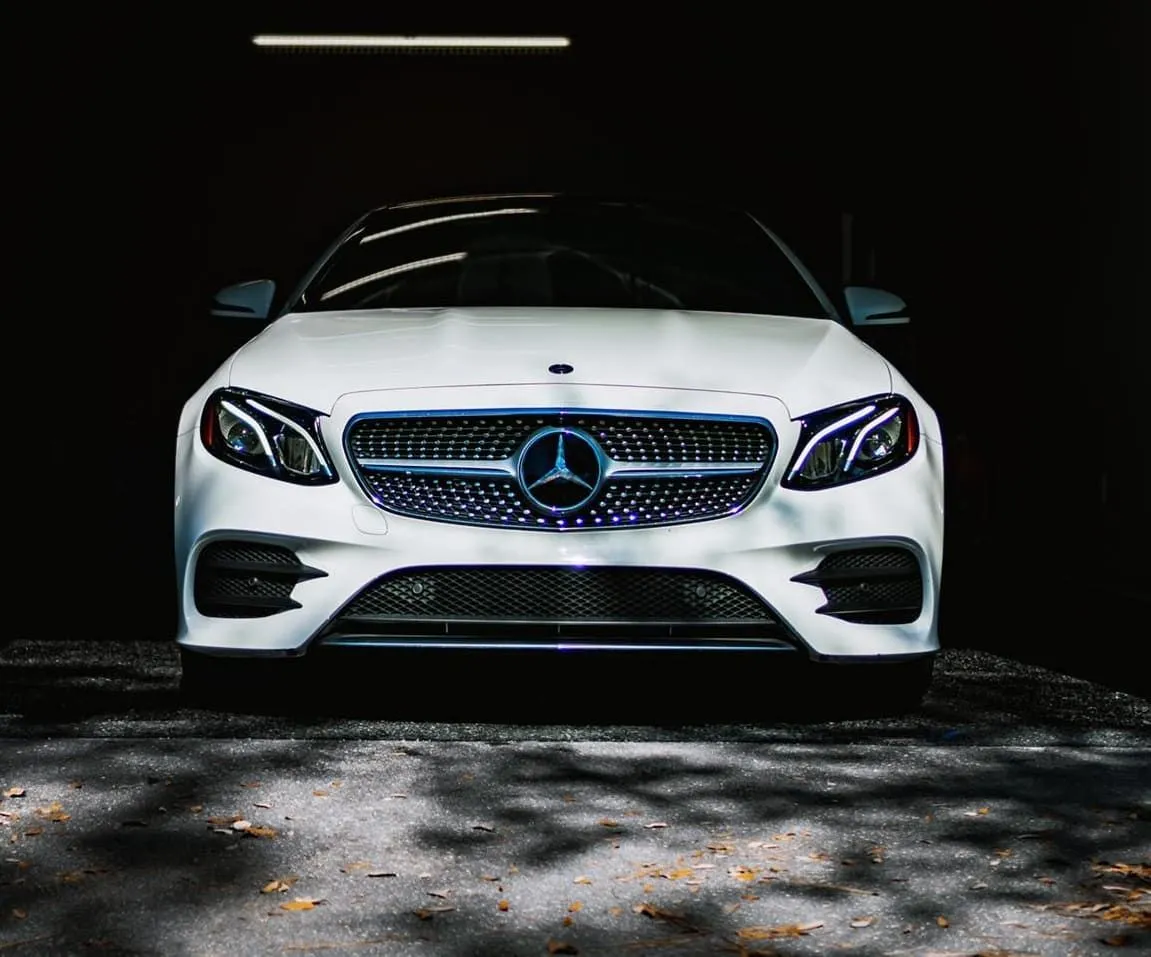 White Mercedes-Benz coupe with a black grille