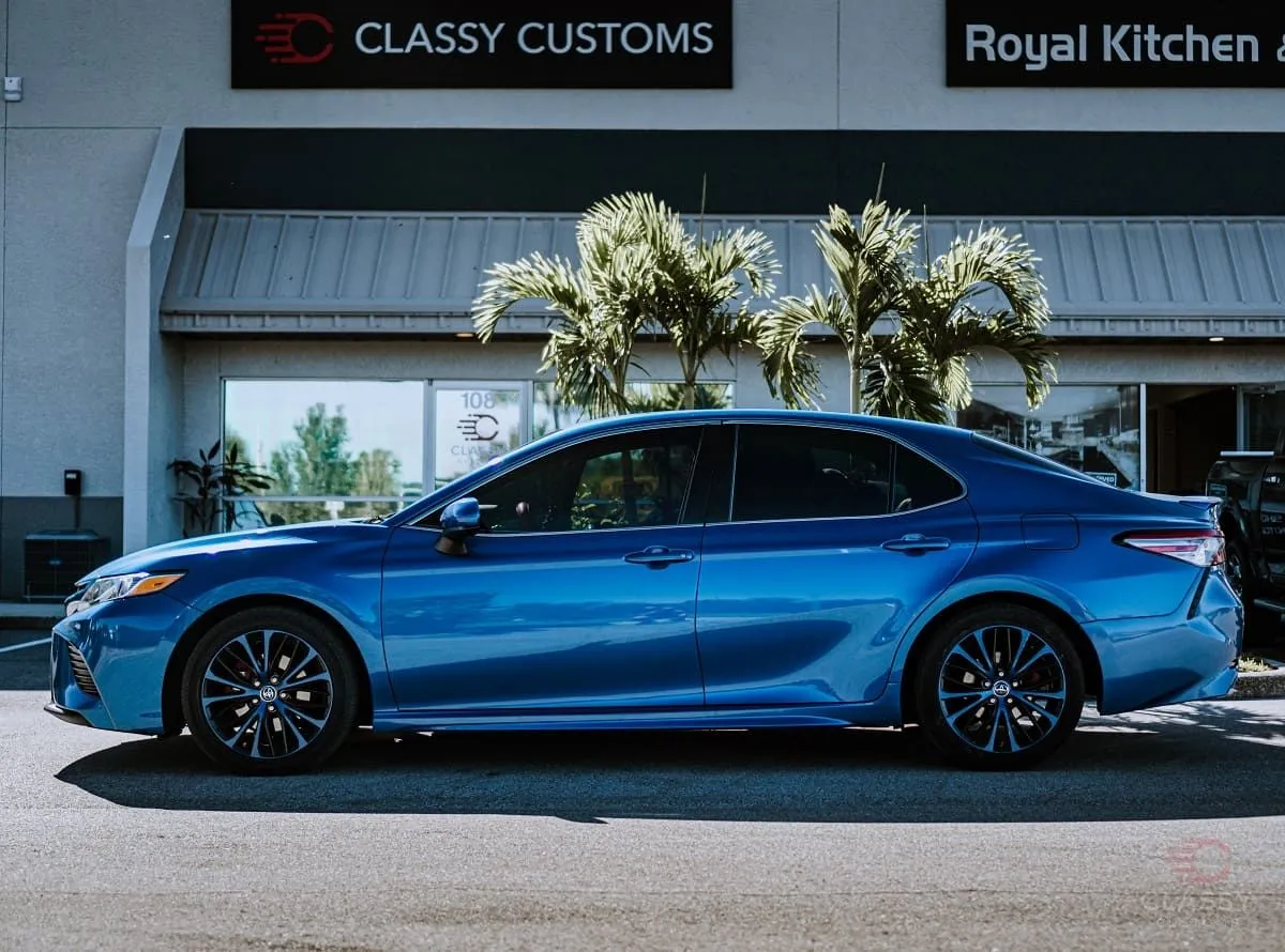 Blue Toyota Camry in front of the Classy Customs storefront