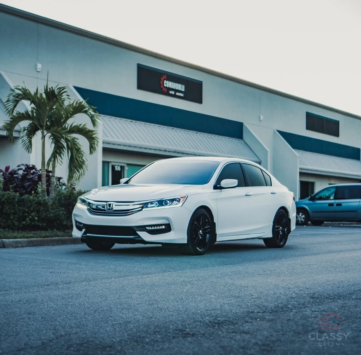 White Honda Accord in front of the shop