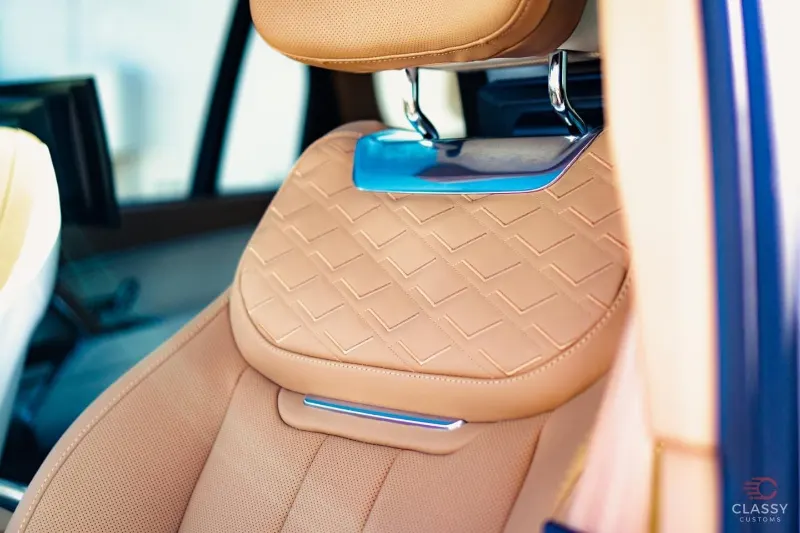 Quilted tan leather front seats inside a luxury SUV