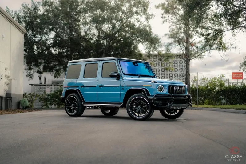 Blue Mercedes-AMG G-Class parked under oak trees