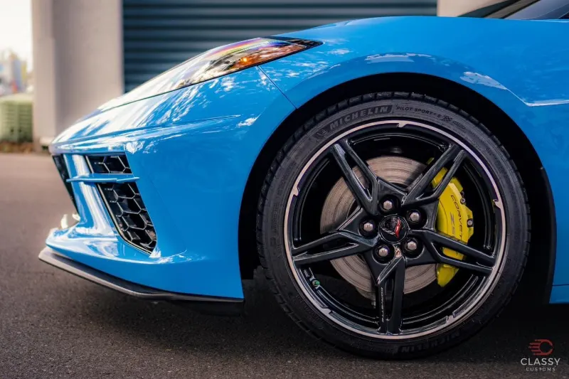 Blue Corvette wheel with a yellow brake caliper