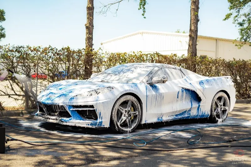 Corvette C8 covered in foam during a wash
