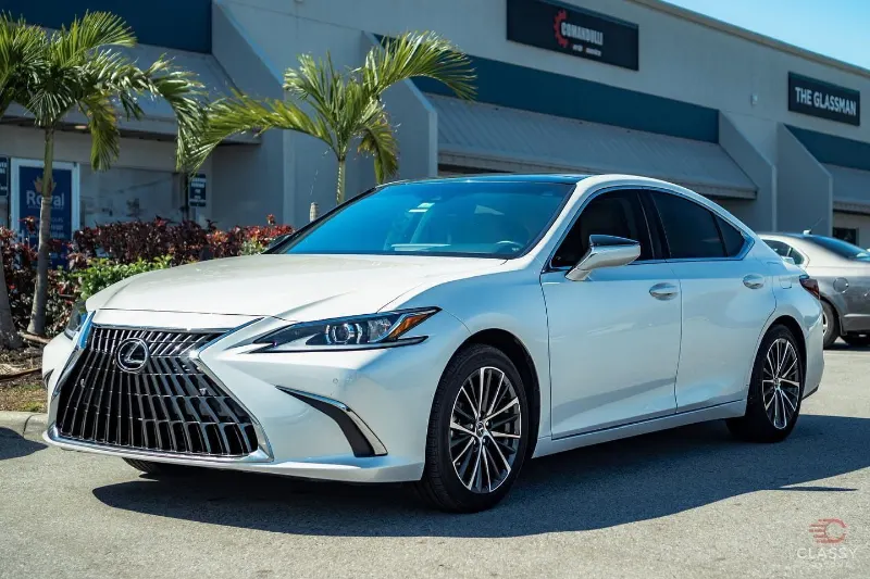 White Lexus sedan in front of the shop