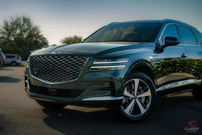 Dark green Genesis SUV with tinted windows