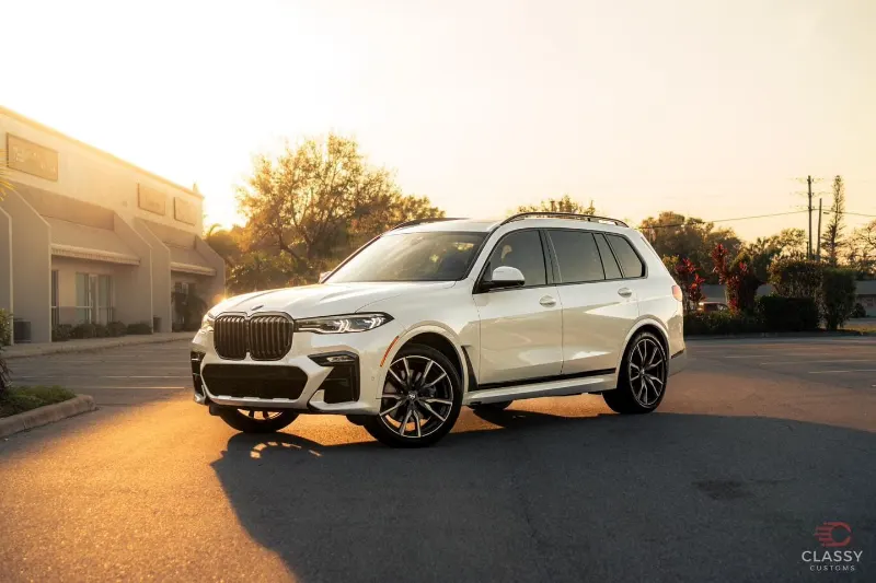 White BMW X7 at sunset