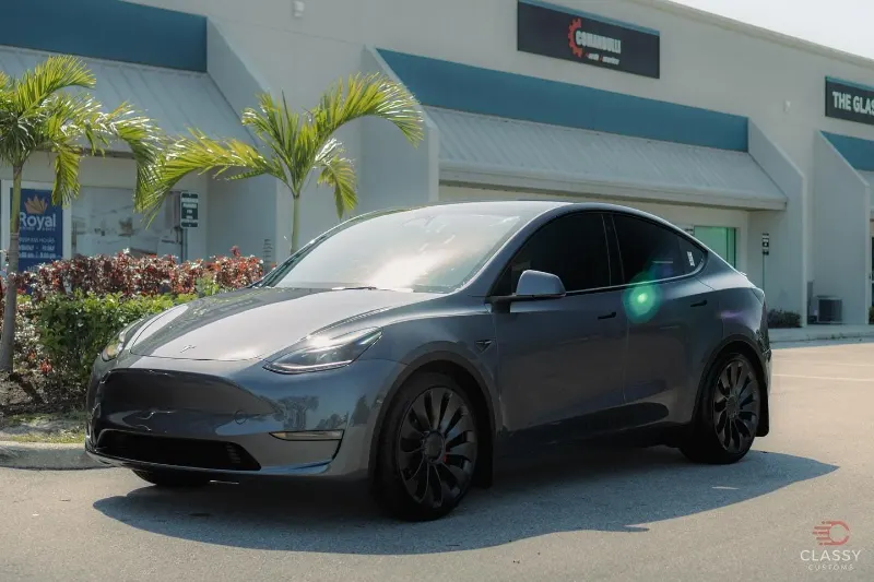 Gray Tesla Model Y outside the shop