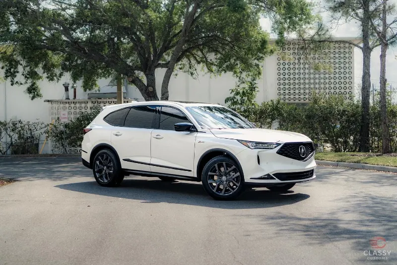 White Acura SUV with tinted windows