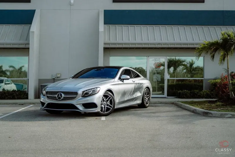 Silver Mercedes-Benz coupe in front of the shop