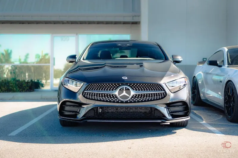 Black Mercedes-AMG sedan in front of the shop