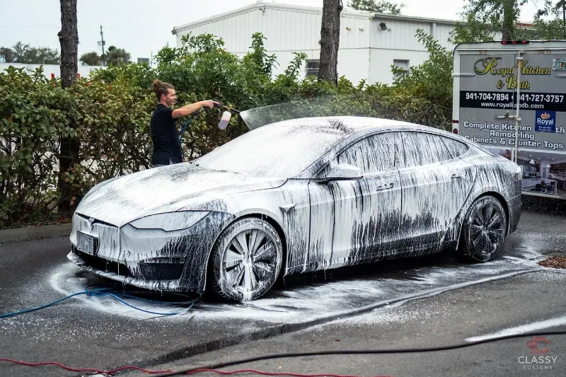 Sports car covered in foam during a hand wash