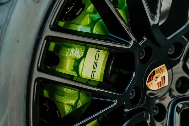 Lime green brake caliper behind a black wheel