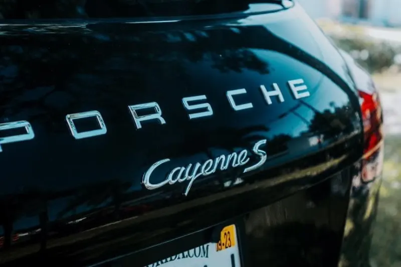 Porsche Cayenne S badge on gloss black paint