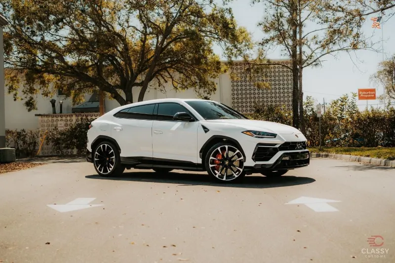 White Lamborghini Urus in the shop parking lot