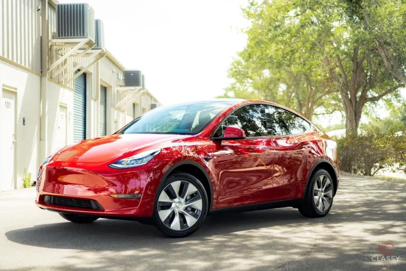 Red Tesla Model Y outside the shop