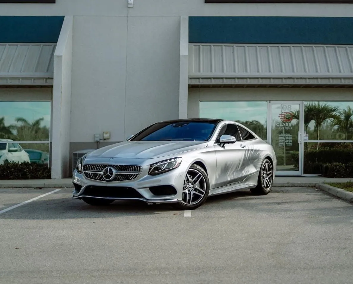 Silver Mercedes-Benz coupe in front of the shop