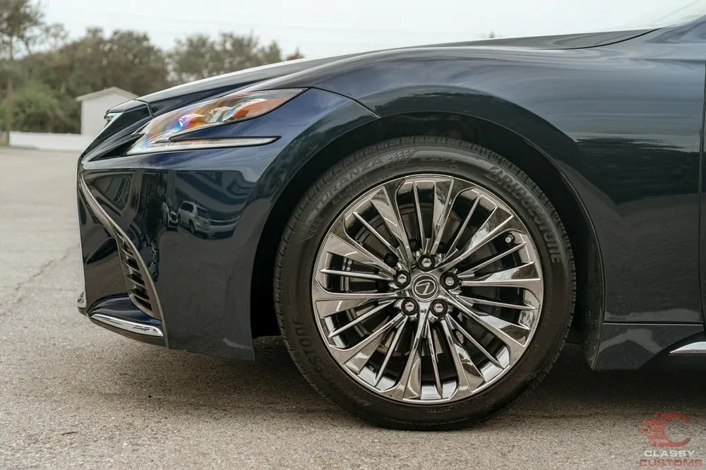 Chrome wheel on a dark Lexus sedan