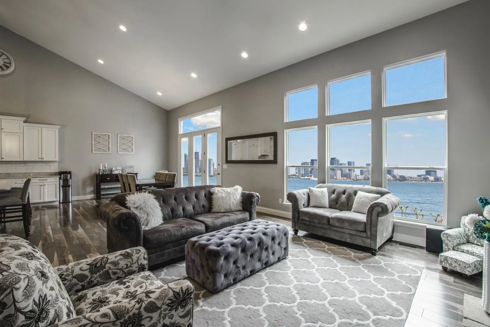 Living room with tall windows overlooking the water