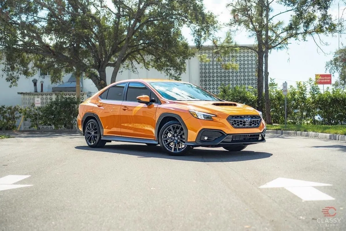 Orange Subaru WRX with tinted windows
