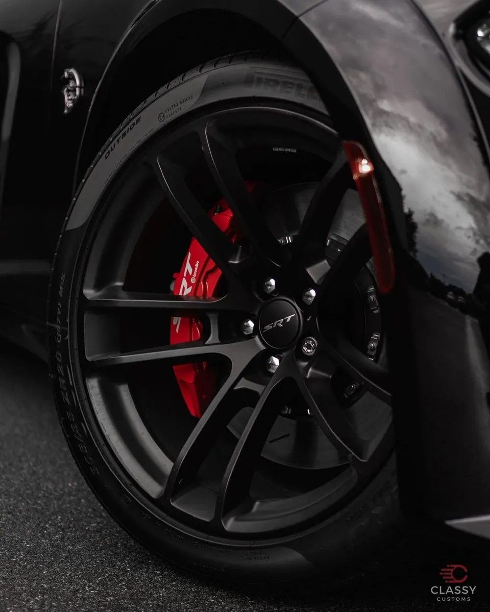 Black wheel with a red brake caliper