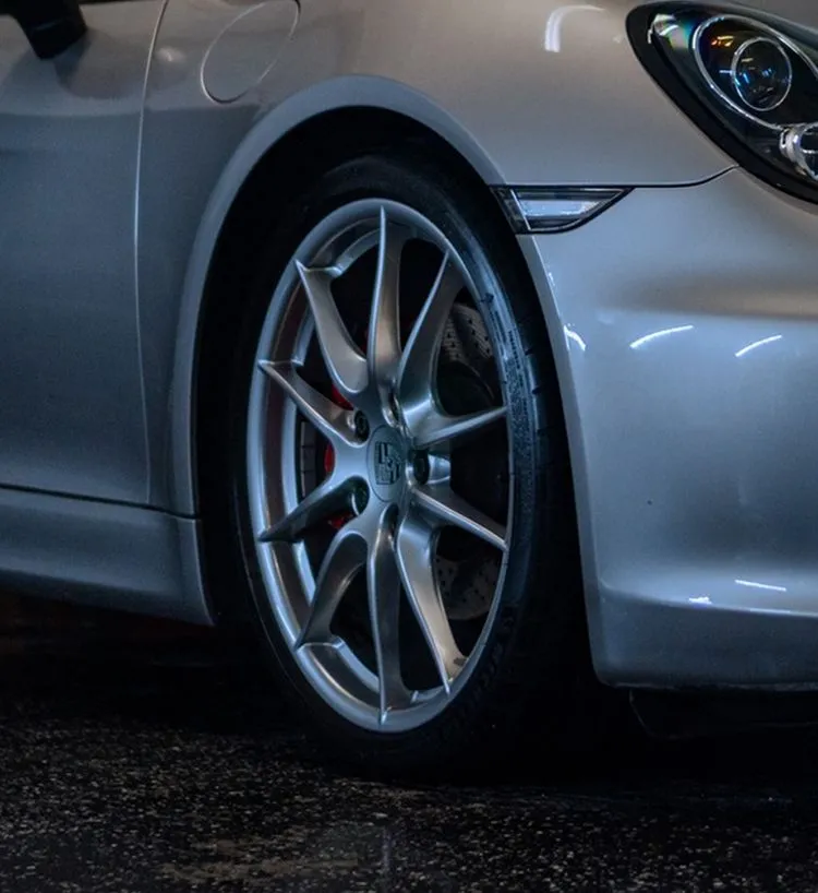 Gray multi-spoke wheel on a silver sports car